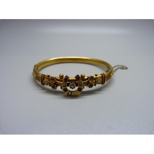 1091 - A Victorian 15ct gold, diamond and ruby horseshoe bangle, Chester 1892, 10.2g, cased