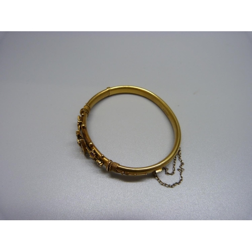 1091 - A Victorian 15ct gold, diamond and ruby horseshoe bangle, Chester 1892, 10.2g, cased