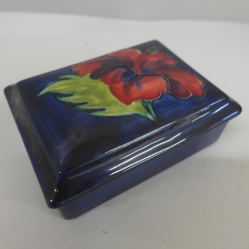 635 - A Moorcroft Hibiscus pattern rectangular box, 11.5 x 8.25cm