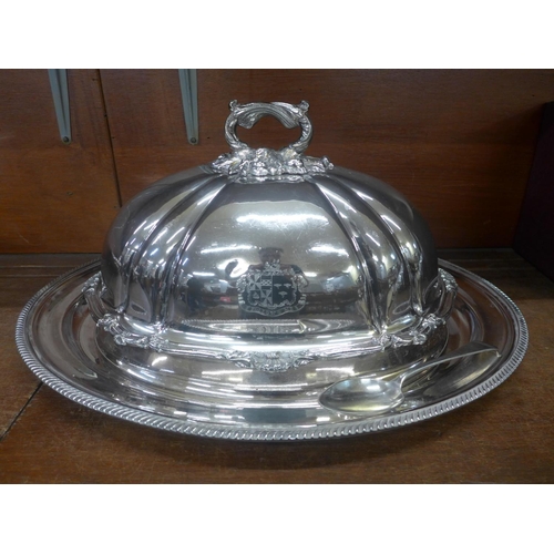 659 - A silver plated meat dome with armorial crest, an associated large tray and spoon