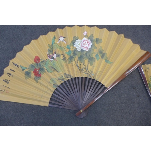 668 - A large hand painted Chinese fan and one smaller