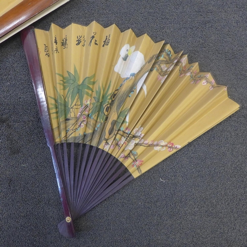 668 - A large hand painted Chinese fan and one smaller