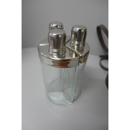 669 - A travel set of three hip flasks in a canvas case