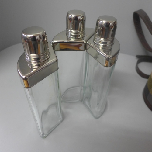 669 - A travel set of three hip flasks in a canvas case