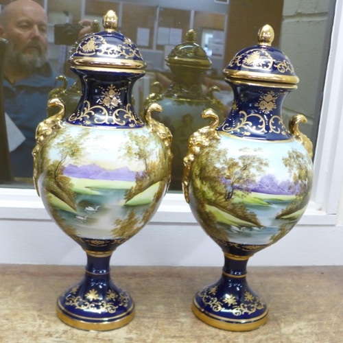 690 - A pair of Limoges cobalt blue lidded vases with transfer printed and painted portrait decoration and... 