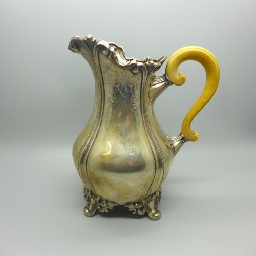 700 - A 19th century continental white metal jug with ivory handle. This lot is offered for sale with non-... 