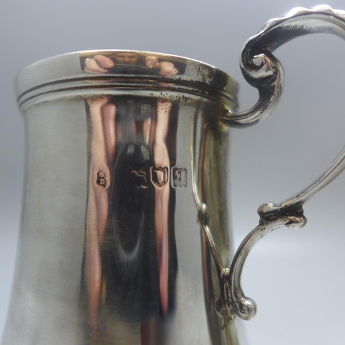 710 - A silver mug, London 1931, 136g, and one other mug