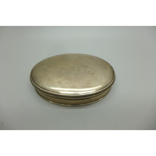 722 - A 19th Century oval white metal box, inside lid bears hand painted island scene, 76mm wide