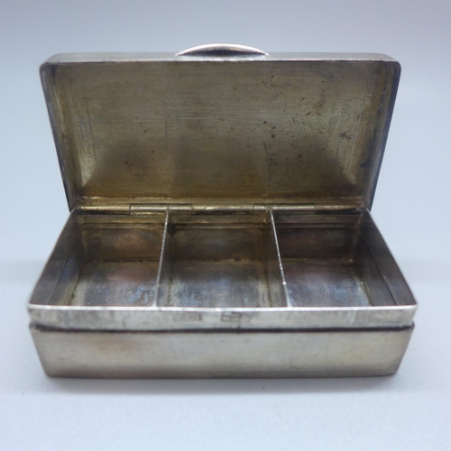 724 - A white metal box, with control marks, 74mm wide