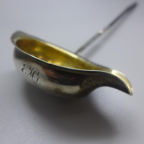 763 - A George III silver gilt ladle, London 1785, incuse duty mark