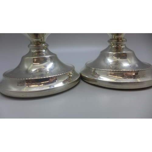 767 - A pair of small silver candlesticks