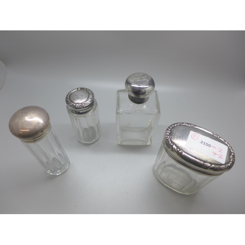 787 - Four silver topped glass bottles, one a/f