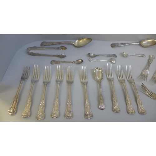 811 - A collection of silver and white metal King's pattern flatware, 1,167g of hallmarked silver, (four w... 