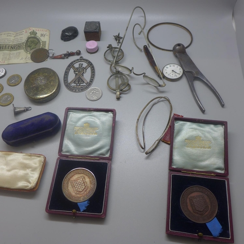 822 - Assorted items including a pill box, spectacles, a silver medallion, one other medallion, a silver l... 