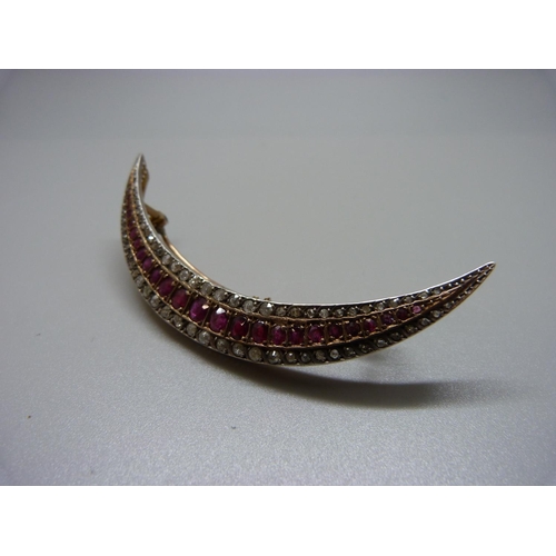 856 - A large c1900 crescent moon shaped brooch set with rubies and diamonds, 16.7g, 8.5cm