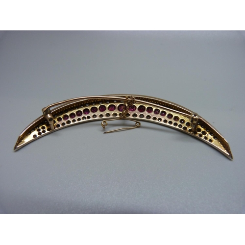 856 - A large c1900 crescent moon shaped brooch set with rubies and diamonds, 16.7g, 8.5cm