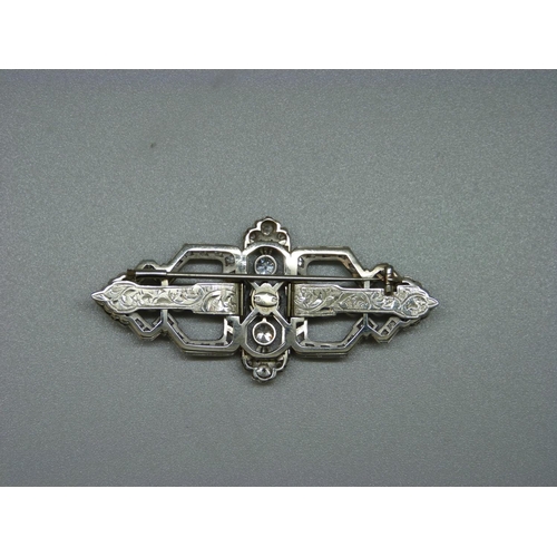 871 - A white metal and diamond set Art Deco brooch/collar clips, the centre stone approximately 0.75ct di... 