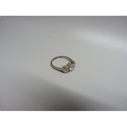 899 - An 18ct gold, three stone diamond ring, the centre stone approximately 0.75 carat weight, 3.7g, P