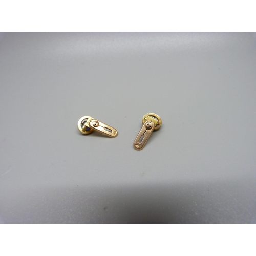 910 - A pair of small yellow metal, cabochon sapphire, diamond and enamel studs, 3.5g