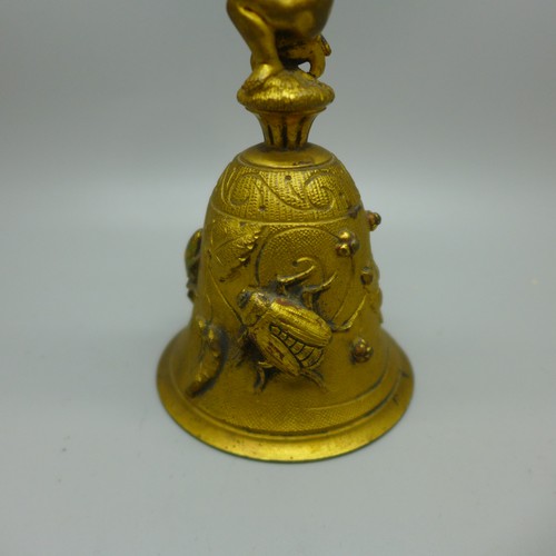 838 - A Victorian aesthetic movement gilt bronze bell with cherub, beetle and insect detail, 118mm