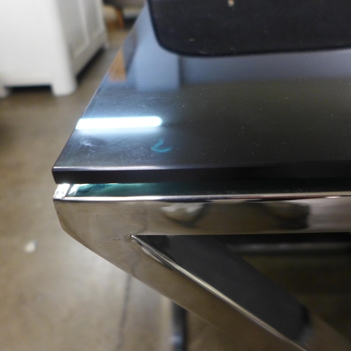 1377 - A chrome and black glass top lamp table