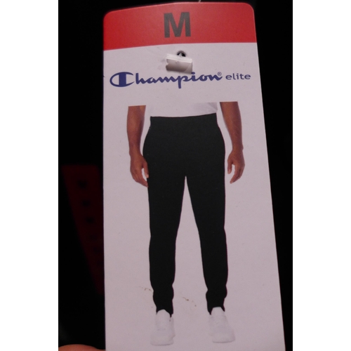 3186 - Men's Champion clothing; black hoodie and navy joggers, both size medium * this lot is subject to VA... 