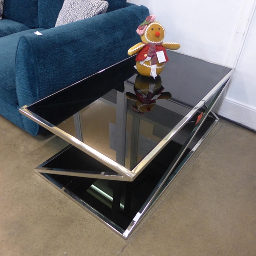 1320 - A chrome and black glass top coffee table