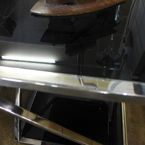 1457 - A chrome and black glass top lamp table