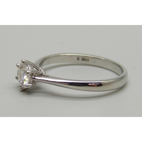 1124 - A white metal and diamond solitaire ring, the shank marked 0.5ct, M