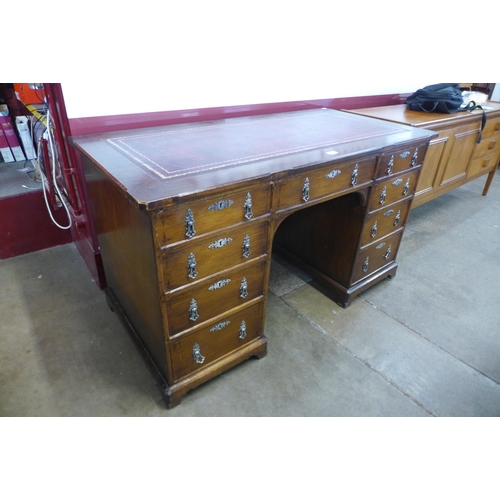 23 - A Victorian Gothic Revival oak and red leather topped desk, manner of A.W.N. Pugin