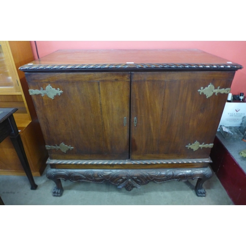 24 - An Edward VII Chippendale Revival carved mahogany press cupboard