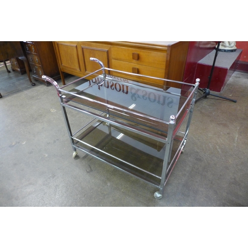 75 - A Merrow Associates chrome and glass topped two tier cocktail trolley