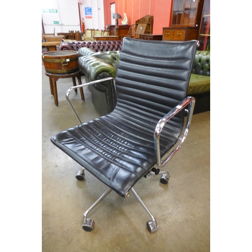 82 - An Eames style chrome and black leather revolving desk chair