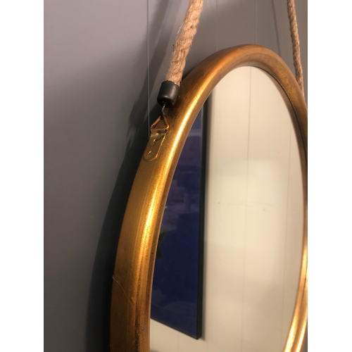 1359 - A large gold metal mirror on hanging rope, 58cms (JRG1114)   #