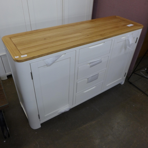 1388 - A Hove white painted and oak two door, four drawer sideboard, slight mark to the back right hand cor... 