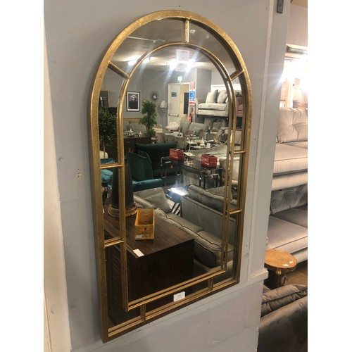 1307 - A gold framed arched mirror