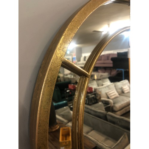 1307 - A gold framed arched mirror