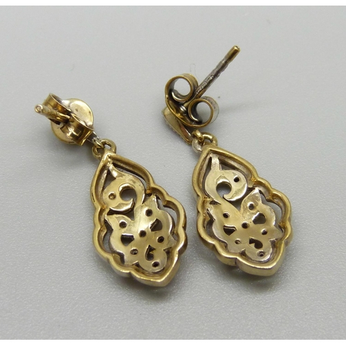 1032 - A pair of silver gilt, fourteen stone black and white diamond earrings