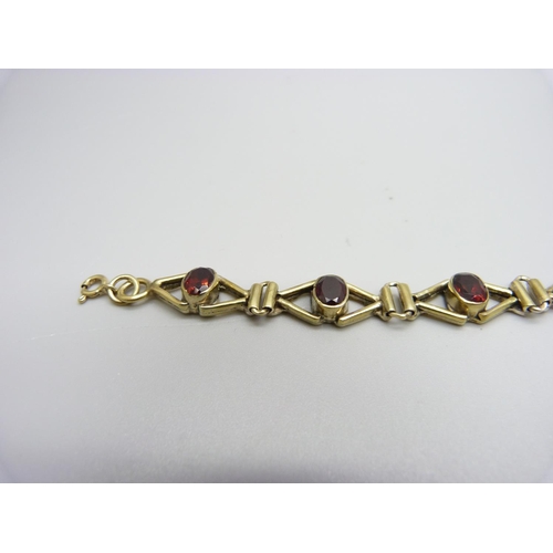 1033 - A silver gilt and garnet bracelet, 19.5cm