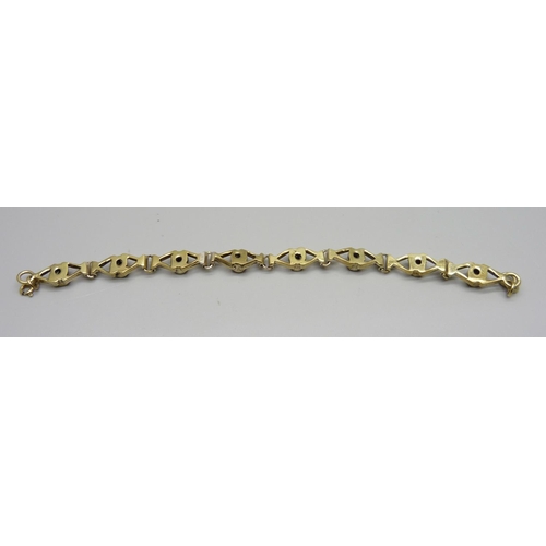 1033 - A silver gilt and garnet bracelet, 19.5cm