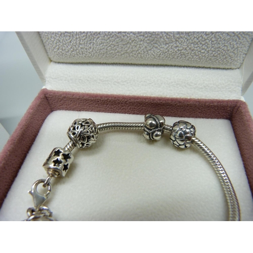 1076 - A silver Pandora charm bracelet with charms and a Pandora clover necklace, both boxed