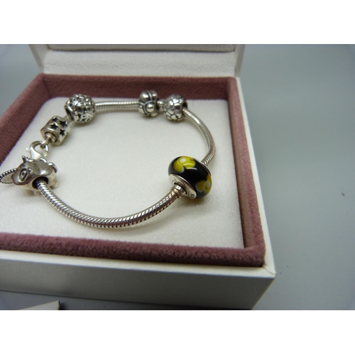 1076 - A silver Pandora charm bracelet with charms and a Pandora clover necklace, both boxed