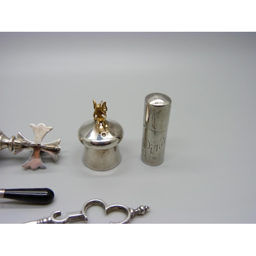 1097 - A silver topped bottle stopper, a pair of Victorian silver sugar nips and other silver items