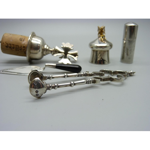 1097 - A silver topped bottle stopper, a pair of Victorian silver sugar nips and other silver items