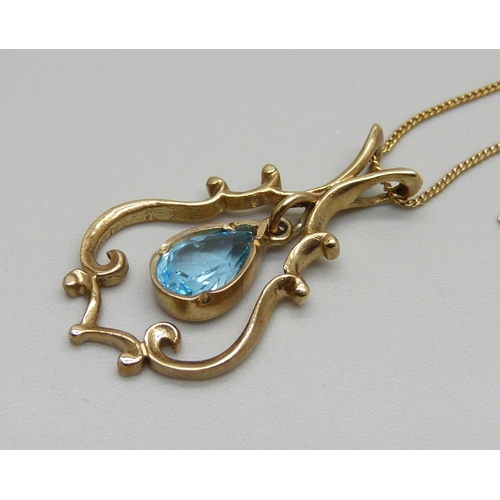 1111 - A 9ct gold and blue topaz stone pendant and chain, 4.4g