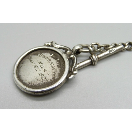 1130 - A silver Albert chain with graduated links and an enamel fob, 34g