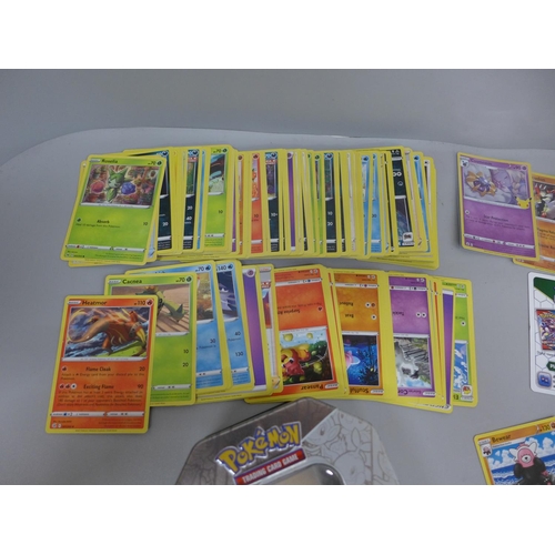 622 - Pokemon cards; a Pokemon collectors tin containing 150 basic Pokemon cards and five holographic card... 