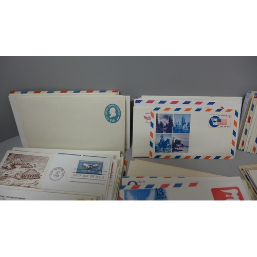 630 - Stamps: a carton of USA postal stationery and first day covers