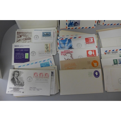 630 - Stamps: a carton of USA postal stationery and first day covers