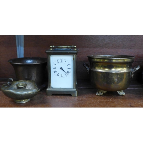 657 - A bronze mortar, brass carriage clock and two other brass items